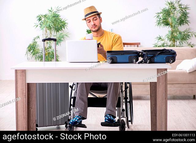Young man in wheel-chair preparing for departure