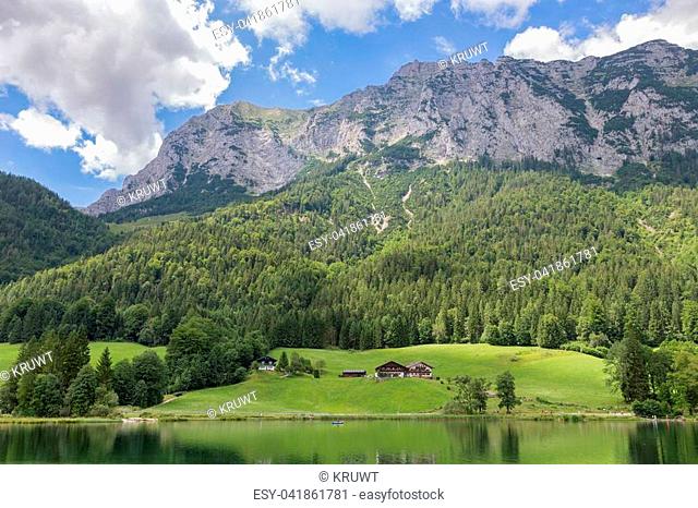 Lake Hintersee near Ramsau in Bavarian alps with blooming flowers and hotels along the lake shore