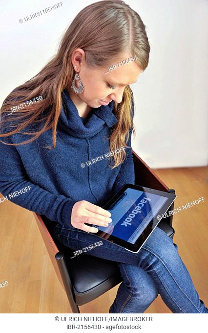 Young woman surfing the internet with an iPad