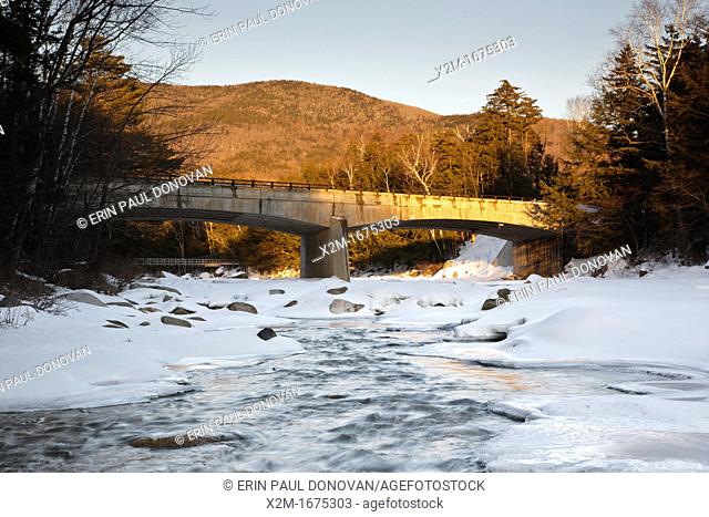 Road Bridge during the in winter months  This bridge crosses the East Branch of the Pemigewasset River in Lincoln, New Hampshire USA along Kancamagus Scenic...