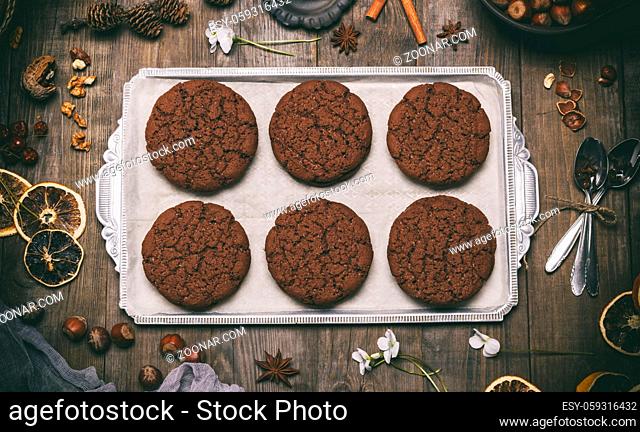 baked round chocolate chip cookies on a silver plate, top view