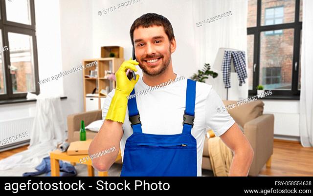 male worker or cleaner calling on phone at home