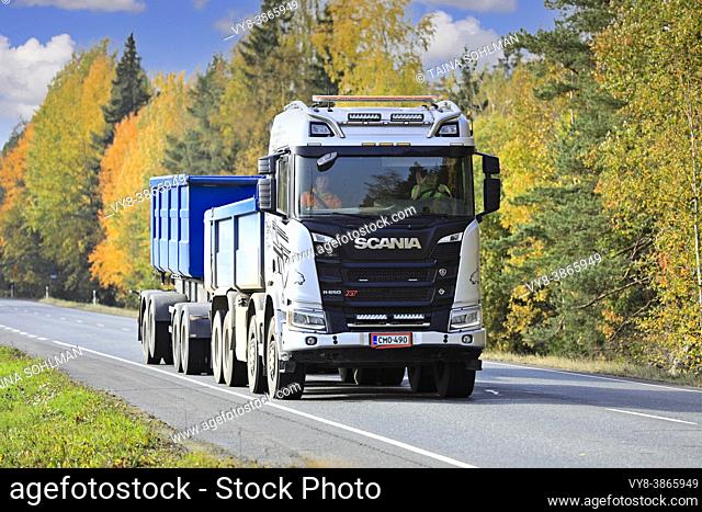 Silver Scania R650 XT truck pulls gravel trailer along Highway 10 on a beautiful day of autumn. Tammela, Finland. October 2, 2020