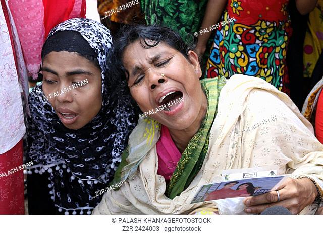 Bangladeshi relatives of victims of Rana Plaza, cry as they gather at the spot on the second anniversary of the garment factory building collapse in Savar