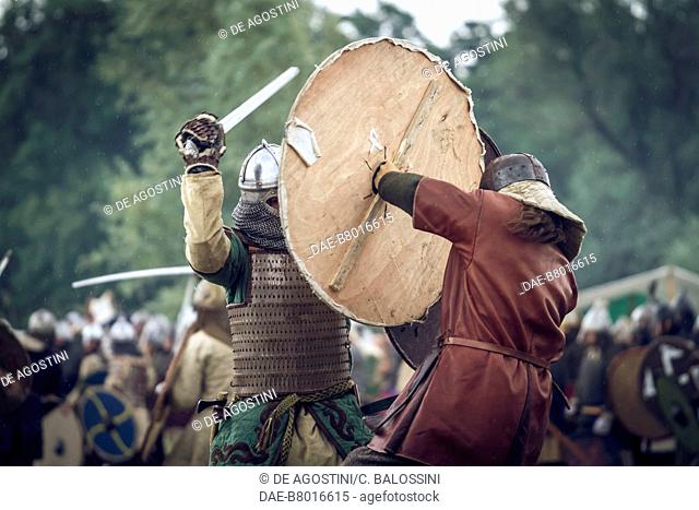 Warriors in battle with swords and shields, Slavic and Viking Festival, Centre of Slavs and Vikings, Jomsborg-Vineta, Wolin island, Poland