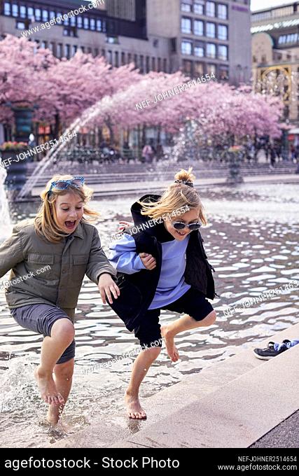 Girls playing in fountain