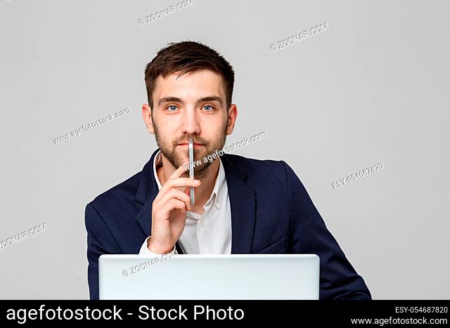 Business Concept - Portrait handsome happy handsome business man in suit playing moblie phone and smiling with laptop at work office. White Background