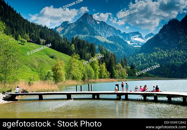 Schwarzsee, FR / Switzerland - 1 June 2019: tourist people enjoy a visit to Lake Schwarzsee in Fribourg as a family vacation destination in the Swiss Alps