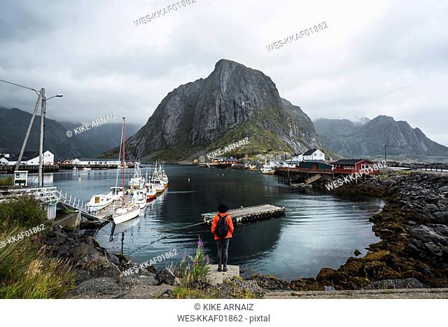 Norway, Lofoten, rear view of man standing at the coast
