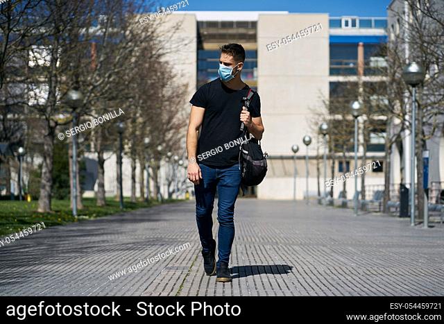 Caucasian male in medical masks walking the streets. The concept of Coronavirus