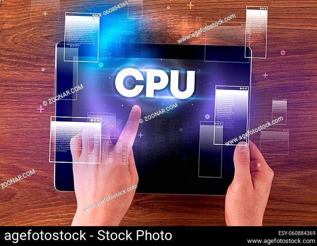 Close-up of a hand holding tablet with CPU abbreviation, modern technology concept
