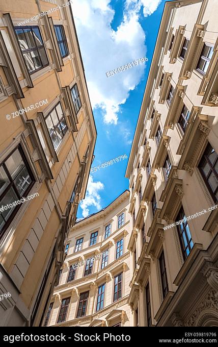 Old buildings with architecture from the Grunderzeit period, in the historical city center of Vienna, Austria, on a sunny day. Low angle view