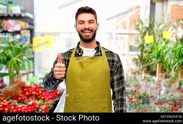 happy gardener showing thumbs up at flower shop