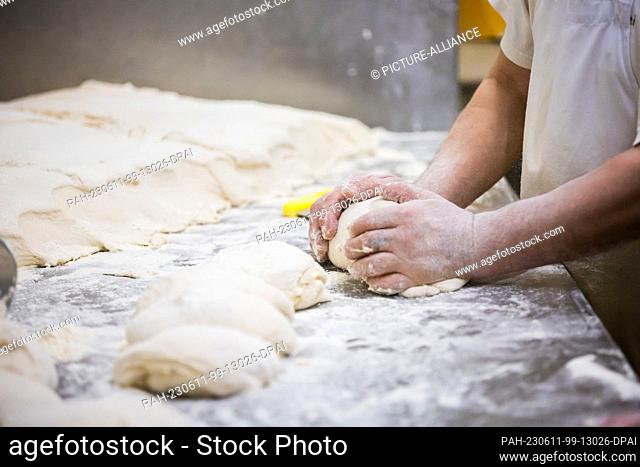 PRODUCTION - 23 May 2023, Berlin: A baker kneads flatbread dough at the Turkish Cevik bakery in Berlin-Wedding. Photo: Christoph Soeder/dpa