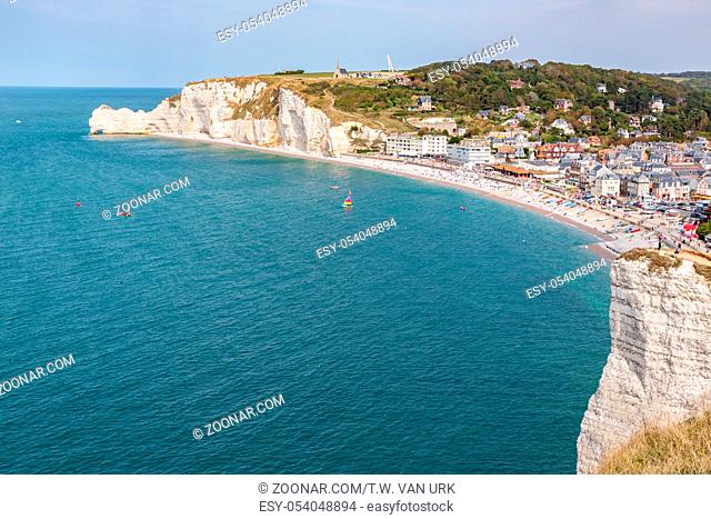 Aerial view promenade and beach of seaside resort Etretat surrounded with beautiful limestone cliffs in Normandy, France