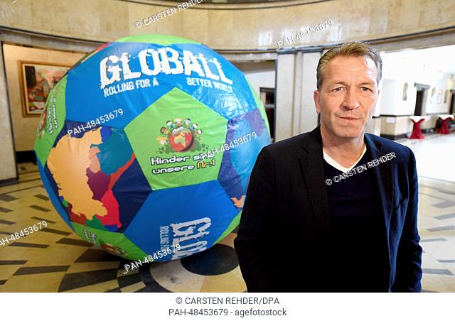 Goalkeeping coach of the German national soccer team Andreas Koepke stands next to a gigantic football in the townhall of Kiel, Germany, 09 May 2014