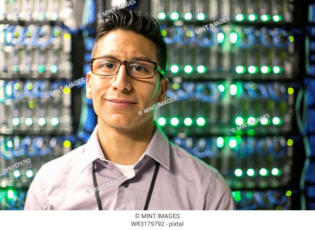 Caucasian man technician in a large computer server farm