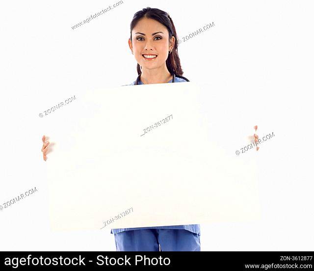 Happy Asian doctor holding an empty billboard isolated over white background