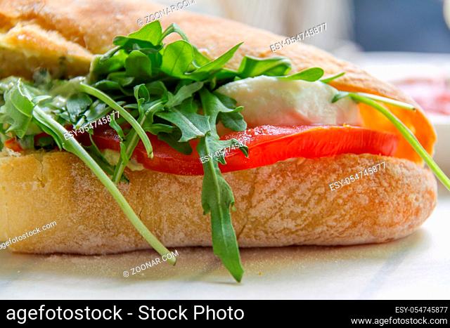 Tomato, rocket and mozarella sandwich close-up photo