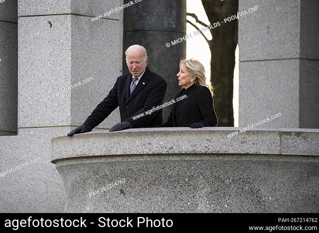 US President Joe Biden (L) and First Lady Jill Biden (R) pay their respects while visiting the World War II Memorial on the 80th anniversary of the attack on...