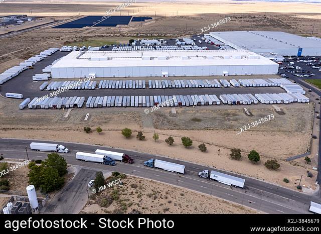 Los Lunas, New Mexico - A Walmart distribution center. Trucks wait their turn on the road outside the warehouse
