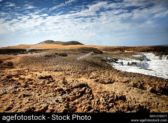 The surf pounds the rocks in the desert landscape of La Guajira, Colombia