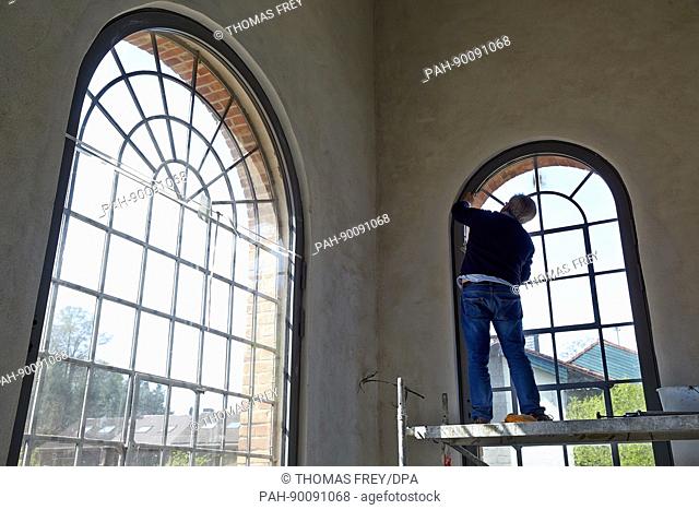 A worker installs a window in the visitor centre of the Sayner Huette (Sayner steel mill) in Bendorf-Sayn, Germany, 20 April 2017