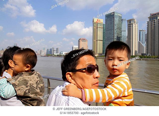 China, Shanghai, Huangpu River, Jinling East Road Dongchang Road Ferry, passengers, Asian, man, father, boy, son, holding, deck, Pudong Xin Qu District