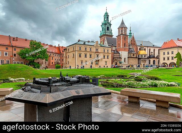 View at Wavel square with medieval buildings and floor plan sculpture during a rainy day in Krakow, Poland