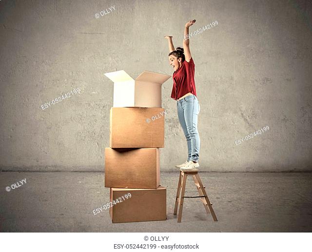 Woman looking into huge boxes