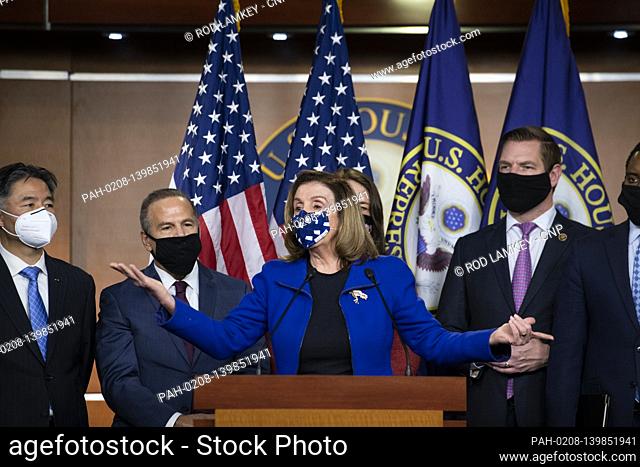 Speaker of the United States House of Representatives Nancy Pelosi (Democrat of California) is joined by the impeachment managers as she offers remarks during a...