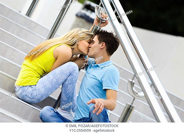 Stock Photo - Teens girl and boy passionate kiss on street