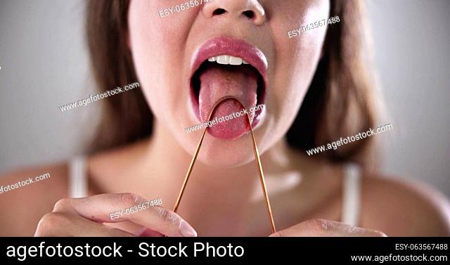Tongue Cleaner Brush Or Scraper. Woman Scraping