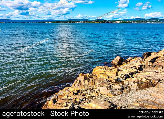 Oslo, Ostlandet / Norway - 2019/09/02: Panoramic view of Oslofjord harbor from rocky recreational cape of Hovedoya island with Londoya island in background