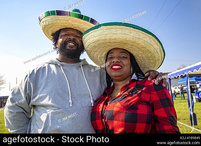 Detroit, Michigan USA - 5 May 2023 - An African-American couple wears sombreros during the celebration of the Cinco de Mayo holiday in the Mexican-American...