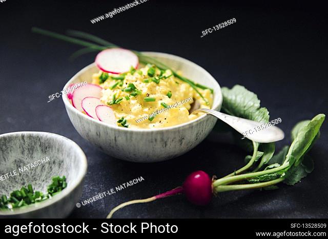Egg salad garnished with radishes and chives