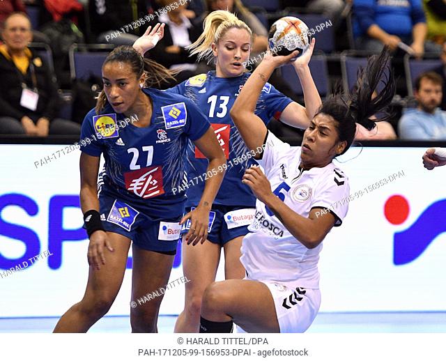 Paraguay's Kamila Araceli Rolon Ledesma (R) in action against France's Estelle Nze Minko (L) and Manon Houette (C) during the World Women's Handball...