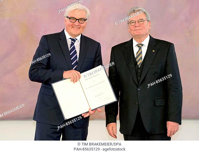ARCHIVE - German Federal President Joachim Gauck (R) hands out the certificate of appointment to Federal Foreign Minister Frank-Walter Steinmeier (R)
