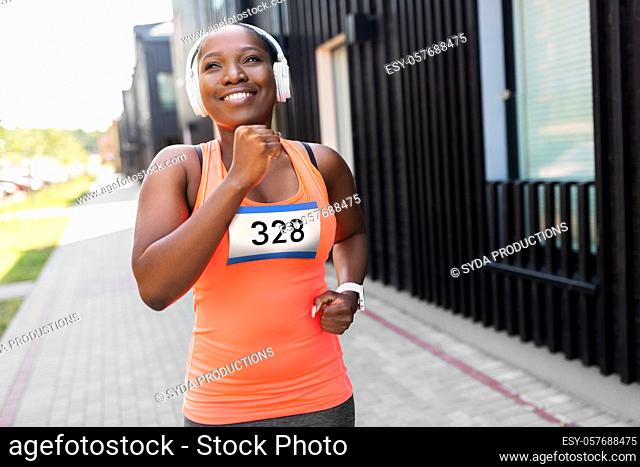happy african american woman running marathon