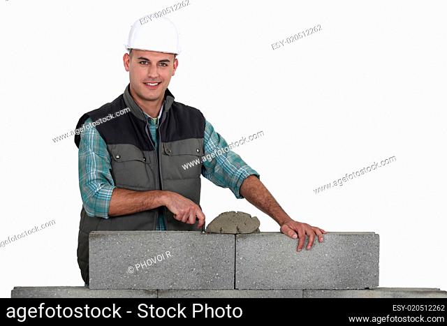 Bricklayer constructing wall