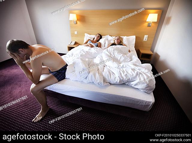 Young couple in the bed in the bedroom, marriage, marital triangle, Photographed at interiors of The Jurys Inn Prague Hotel