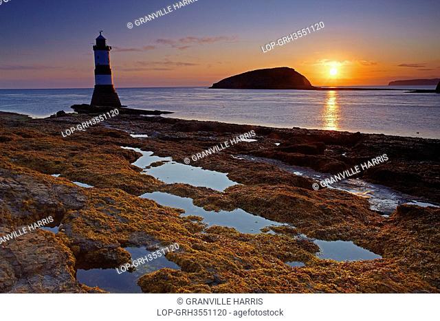 Wales, Anglesey, Penmon Point. Penmon Lighthouse, also known as Menai Lighthouse, at the north entrance to the Menai Strait opposite Puffin Island at sunrise