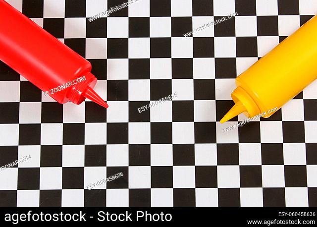 Ketchup and Mustard Bottles on Checkered Table
