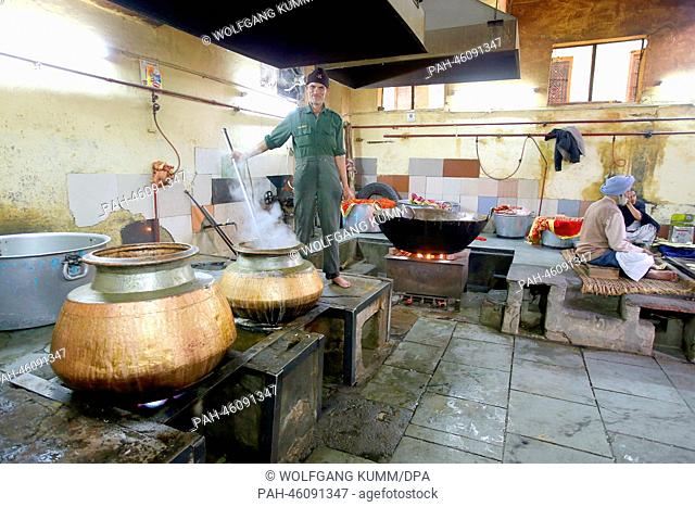 A man prepares food in the great kitchen at the Gurudwara Sis Ganj Sahib Sikh tempel during a tour of New Dehli, India, 05 February 2014