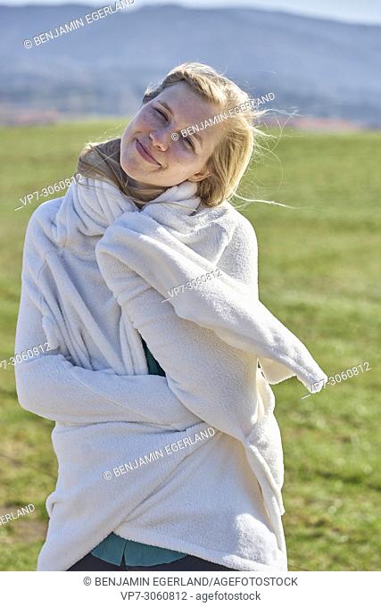 Portrait of woman in nature wearing a white bathrobe. Waakirchen, Bavaria, Germany
