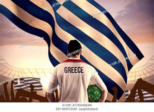 Composite image of greece football player holding ball