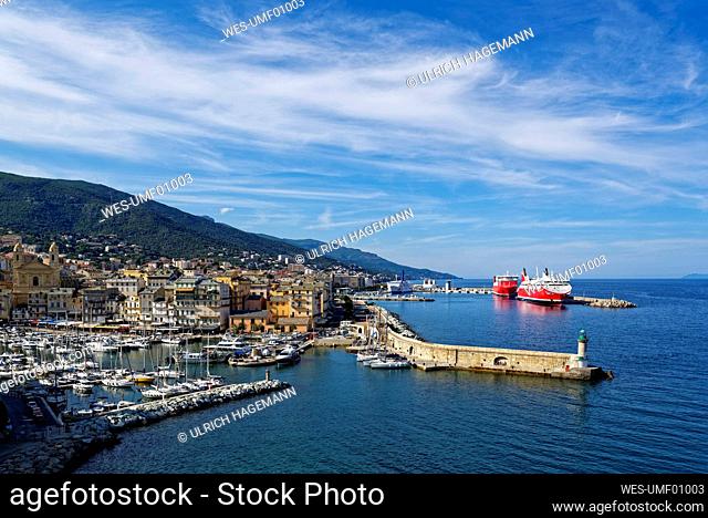 France, Haute-Corse, Bastia, Harbor of coastal town with cruise ship in background