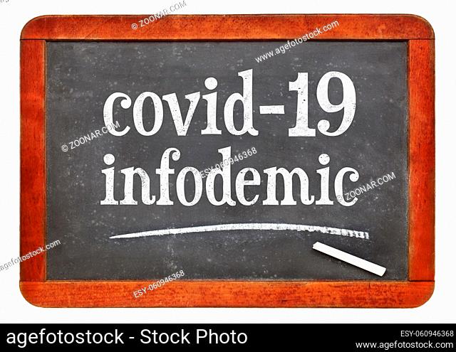 covid-19 infodemic - coronavirus pandemic information overload concept, white chalk text on a vintage slate blackboard