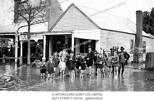 Negative - Rochester, Victoria, circa 1930, Floodwaters in the streets of Rochester. A group of children and four men standing in the water