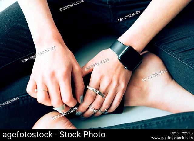 Slender girl with a smart clock on her arm. Indoor